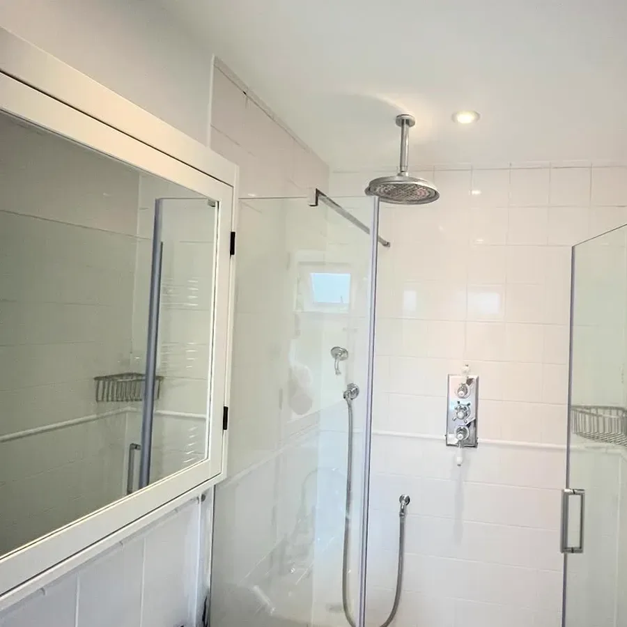 Finished shower room with marble-effect finishes and a mirror